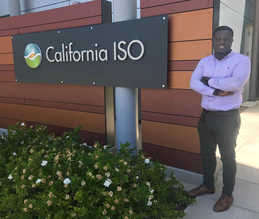 man standing in front of sign that says ISO