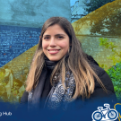 Valeria smiles in France with a gradient overlay of blue, yellow, and green in the background.