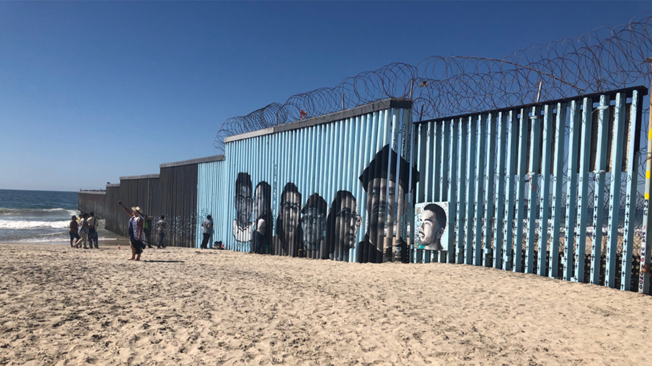 Border wall on the beach with artwork