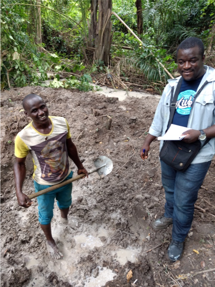 man standing next to a guy with a shovel 