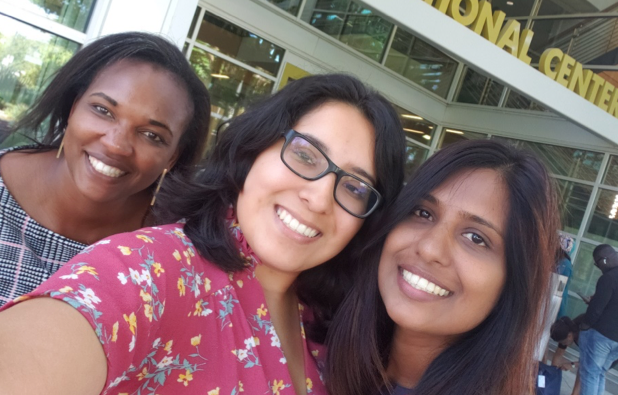 three women smiling into a camera