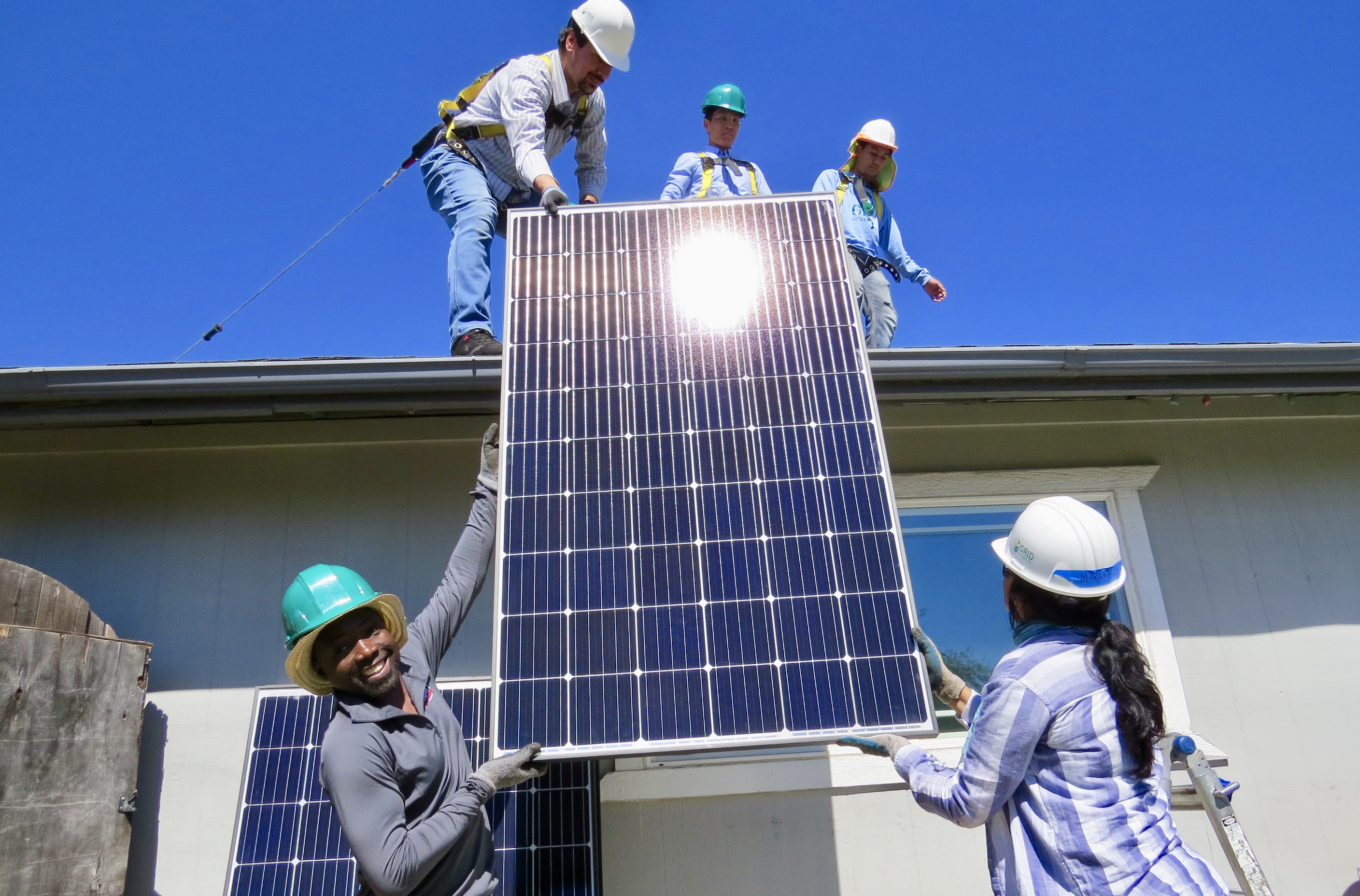 Humphrey Fellows installing solar panels