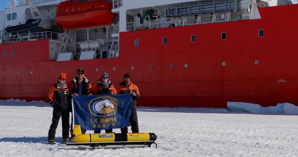 UC Davis doctoral students Cordielyn Goodrich, Andrew Friedrichs and Jasmin McInerney with EPFL’s Sebastian Lavanchy and the glider Storm Petrel on the ice beside icebreaker R/V Araon at Jang Bogo Station in Antarctica, January 2019. (Joe Haxel, OSU/NOAA)