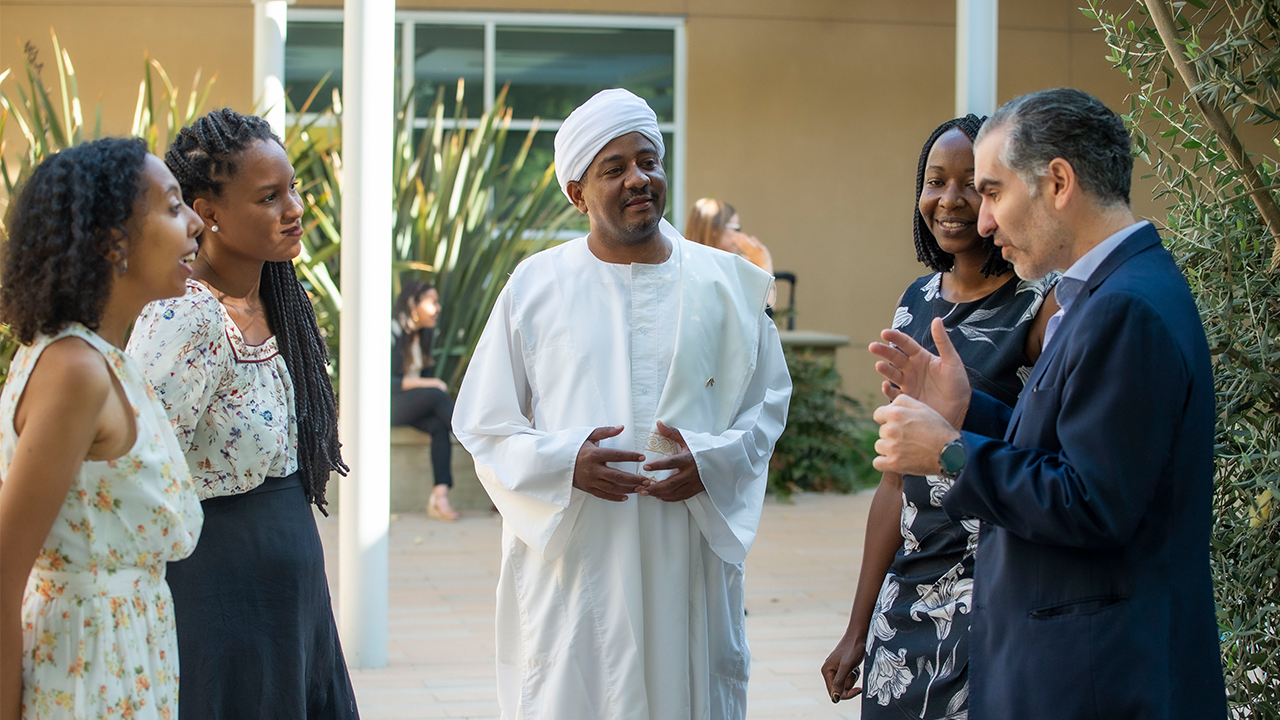 From left to right, Ruth Tekle Andemariam, Andréia Coutinho Louback, Ahmed Osman Elamin Abdalgader, Shelia Nabwire Apopo and José Palma speak outside the International Center. 