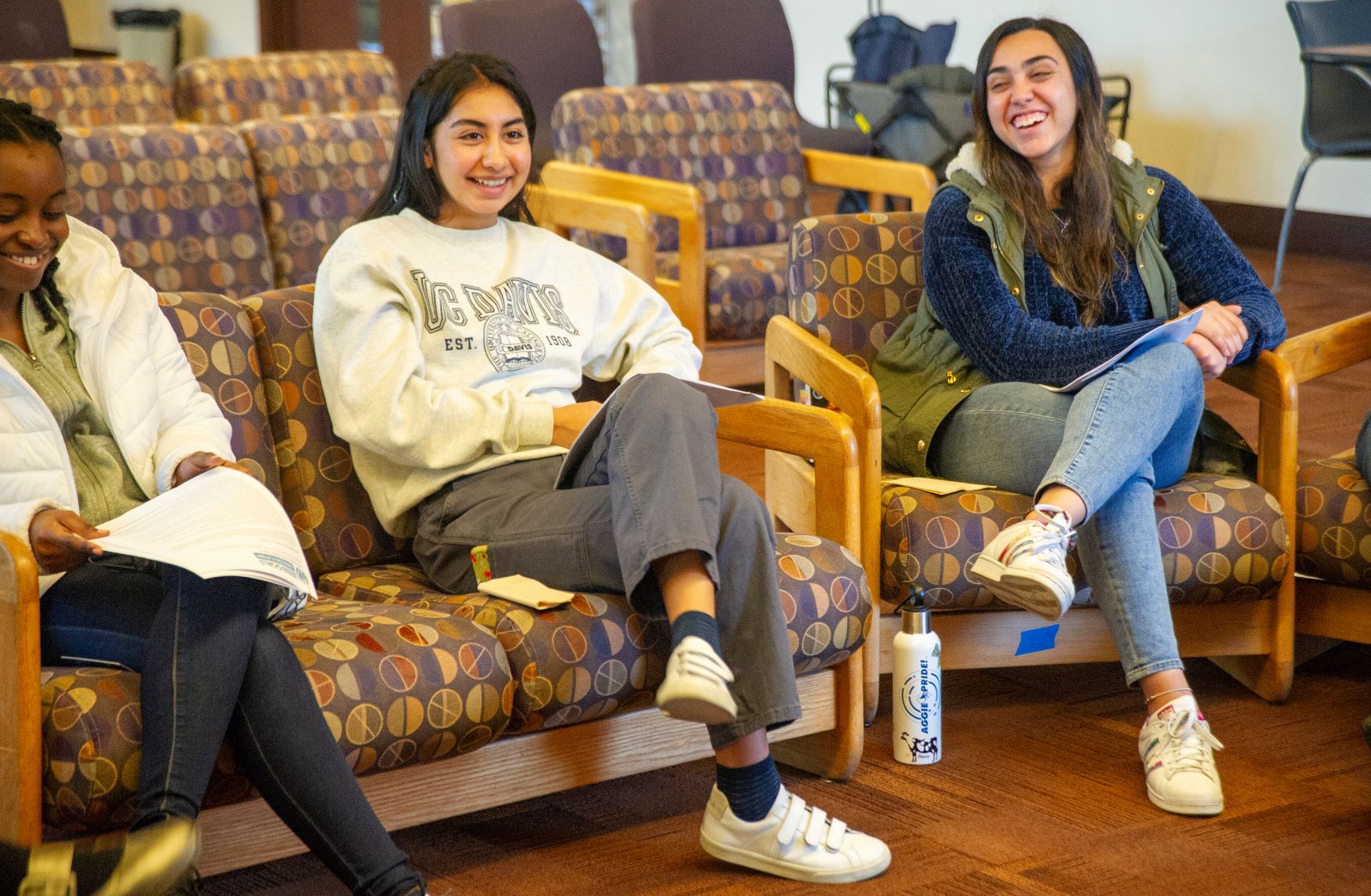 Photo of three students in the Global Engagement Opportunity Living Learning Community smiling and laughing