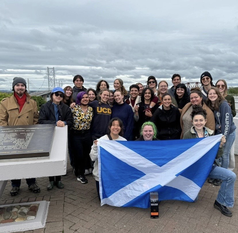UC Davis student Anya Nygaard and her cohort as they hold up the national flag of Scotland