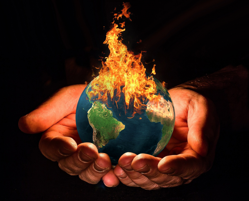 globe on fire cradled in hands