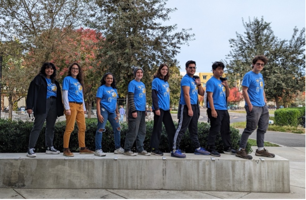 Group of students standing in a line and smiling.