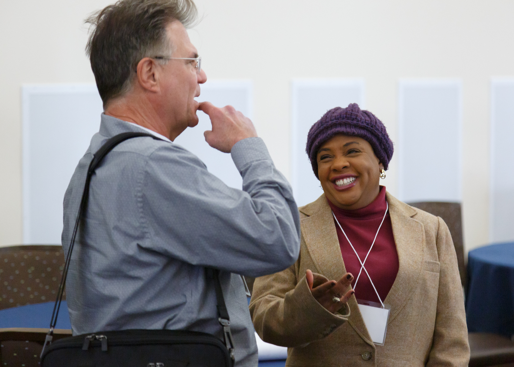 Melinda Livas and Brad Henderson talking at a conference