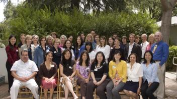 A group of colleagues smile at the campera
