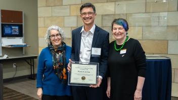  Nancy Erbstein, David de la Pena and Joanna Regulska smile at the camera while holding an award