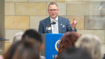 Michael Lazzara speaks from a podium