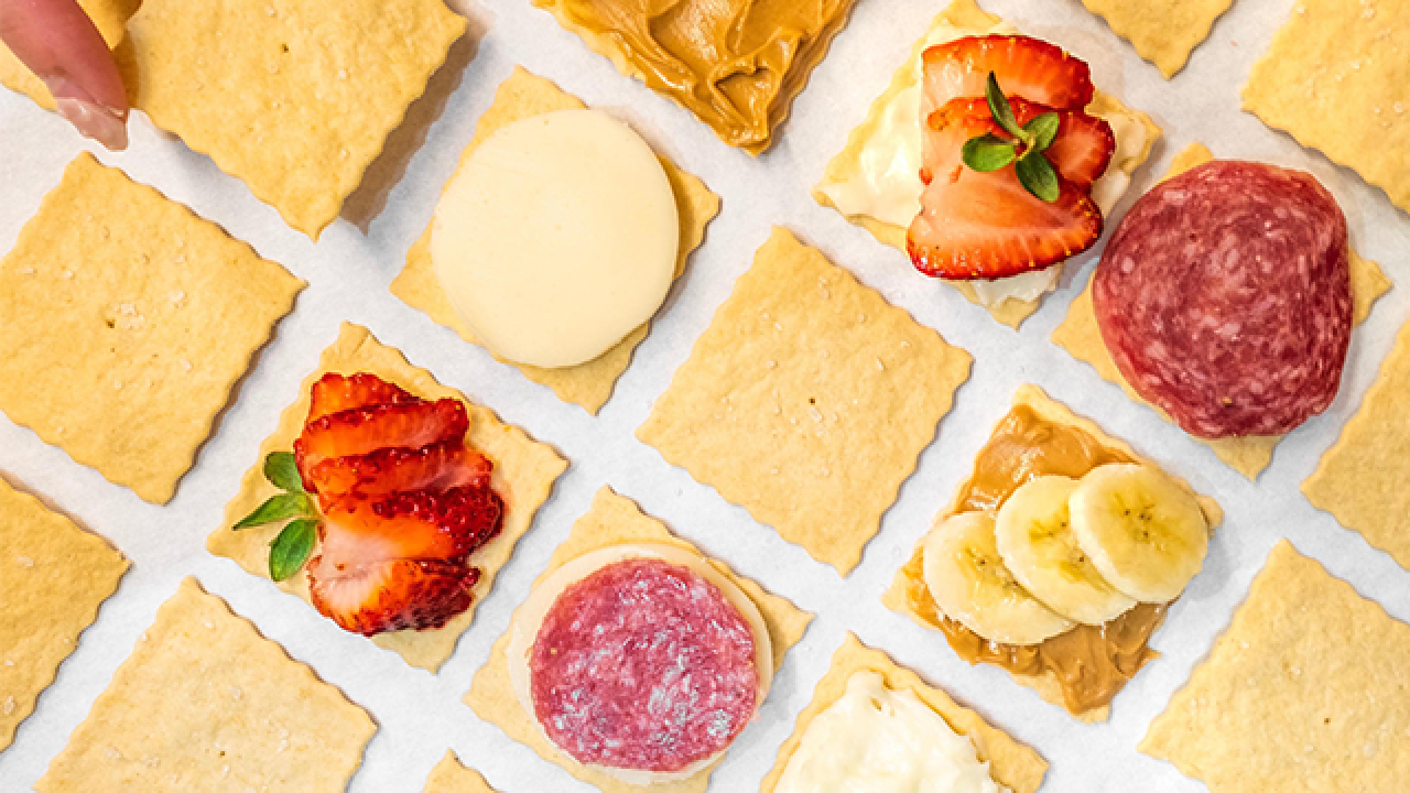 crackers with different toppings like banana and strawberry and salami