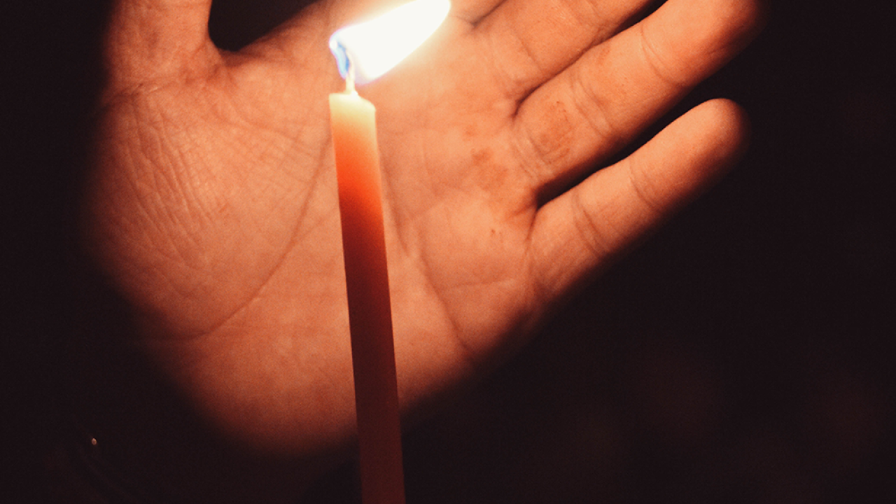 hand holding a candle