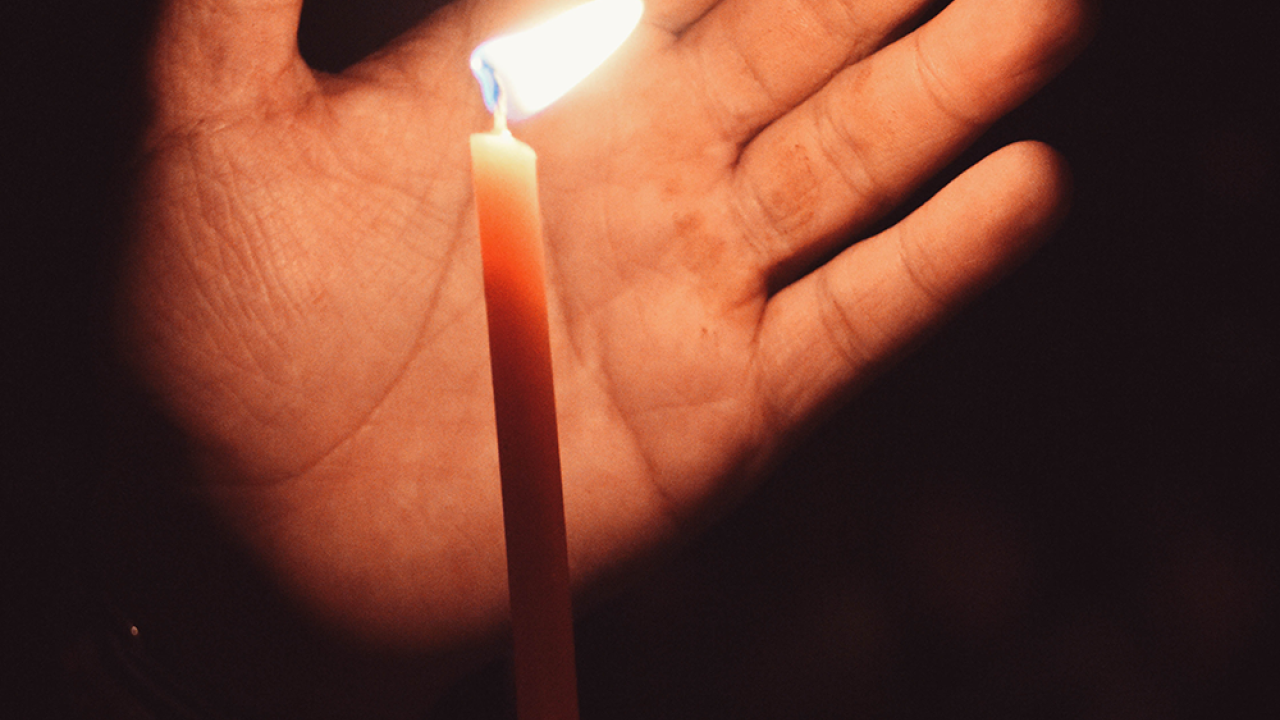 hand holding a candle 