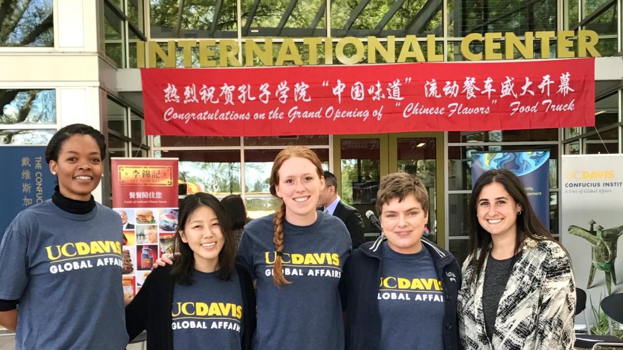 Global Affairs Students Assistants celebrate the opening of the Chinese Flavors Food Truck in front of the International Center (from left: Tene Goodwin, Ariel Lee, Haley Fredericks, Aryss Hearne and Maya Barak). group of students standing in front of the international center