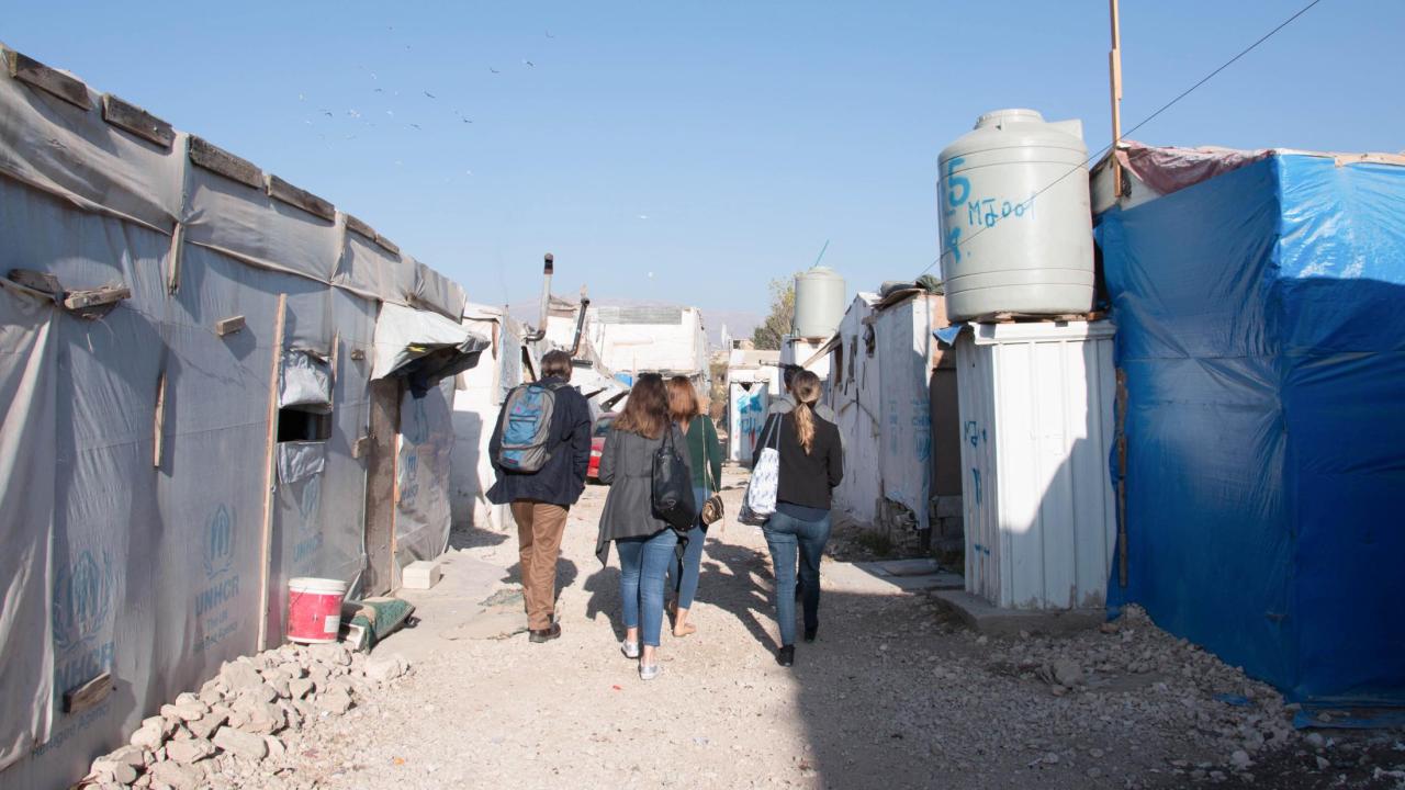 Dr. Watenpaugh and Backpack Guide student volunteers walk through the Jarahiyyah refugee camp in the Biqa' Valley. Watenpaugh with student volunteers