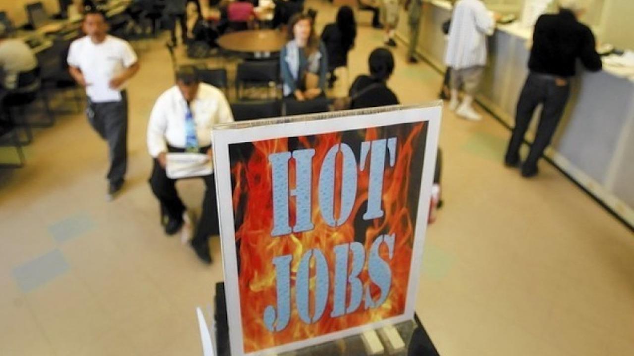 For every skilled worker added to a city, an additional three or four connected jobs are created, a major economic study has found. (Mark Boster / Los Angeles Times) Sign Reading Hot Jobs at employment office