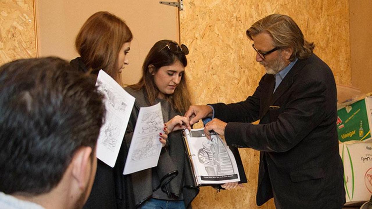 UC Davis professor Keith David Watenpaugh, right, and two trained guides from the American University in Beirut use a comic book to explain Article 26 Backpack at a refugee camp in Lebanon as Jihad Qusanyeh looks on. (Liz McAllister/UC Davis) Professor Watenpaugh in Lebanon