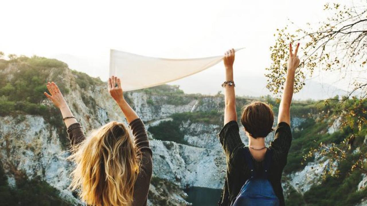 "We want 100% of our students by the time they graduate...to have some form of global and intercultural engagement". Photo: Pexels People with arms in air