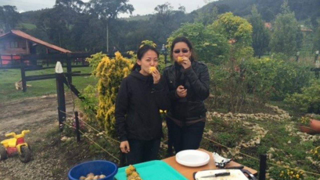 During her 2015 USAID fellowship in Colombia to assess environmental impacts of intensified agriculture in grasslands, Meiling Gao (left) of UC Berkeley enjoys an outdoor barbecue with colleague Juliana Hernández. USAID Fellow in Colombia