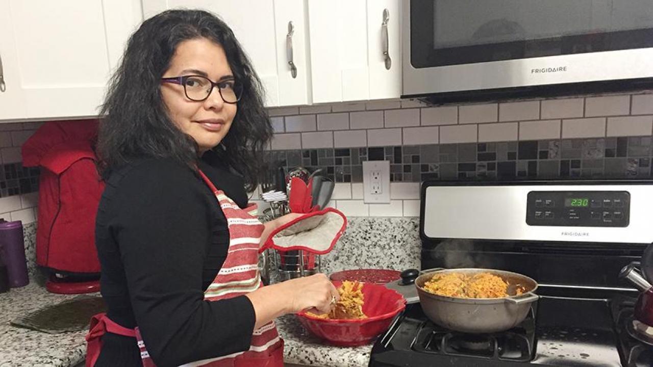 Lilian Cruz-Orengo, assistant professor at the School of Veterinary Medicine and a Puerto Rican herself, looks forward to sharing traditional Puerto Rican dishes with two doctoral students arriving soon from Puerto Rico. (Elba Orengo-Ramirez) Lilian Cruz-Orengo cooking Puerto Rican dishes