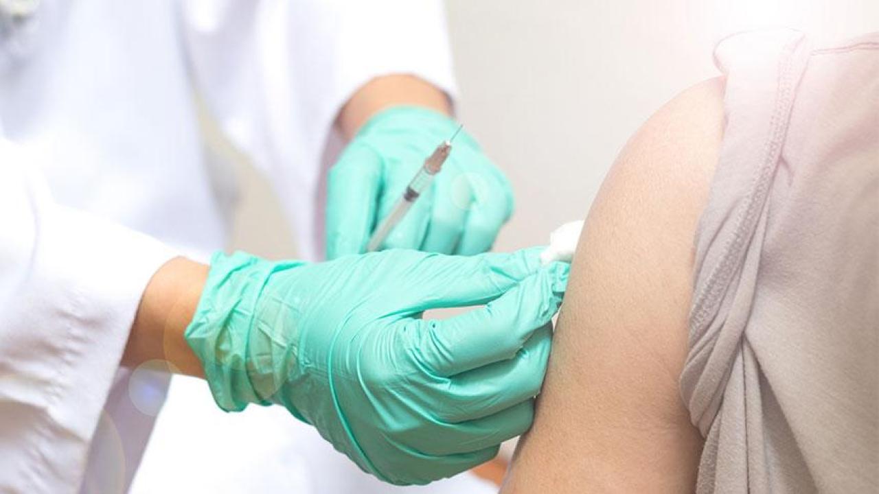 Student Health and Counseling Services has vaccination appointments available for students. (Pornpak Khunatorn/Getty Images) hand in glove vaccinating arm