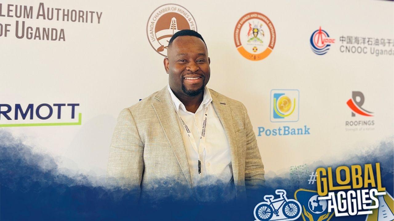 Shingirai Taodzera stands in front of an off-white backdrop with various logos.