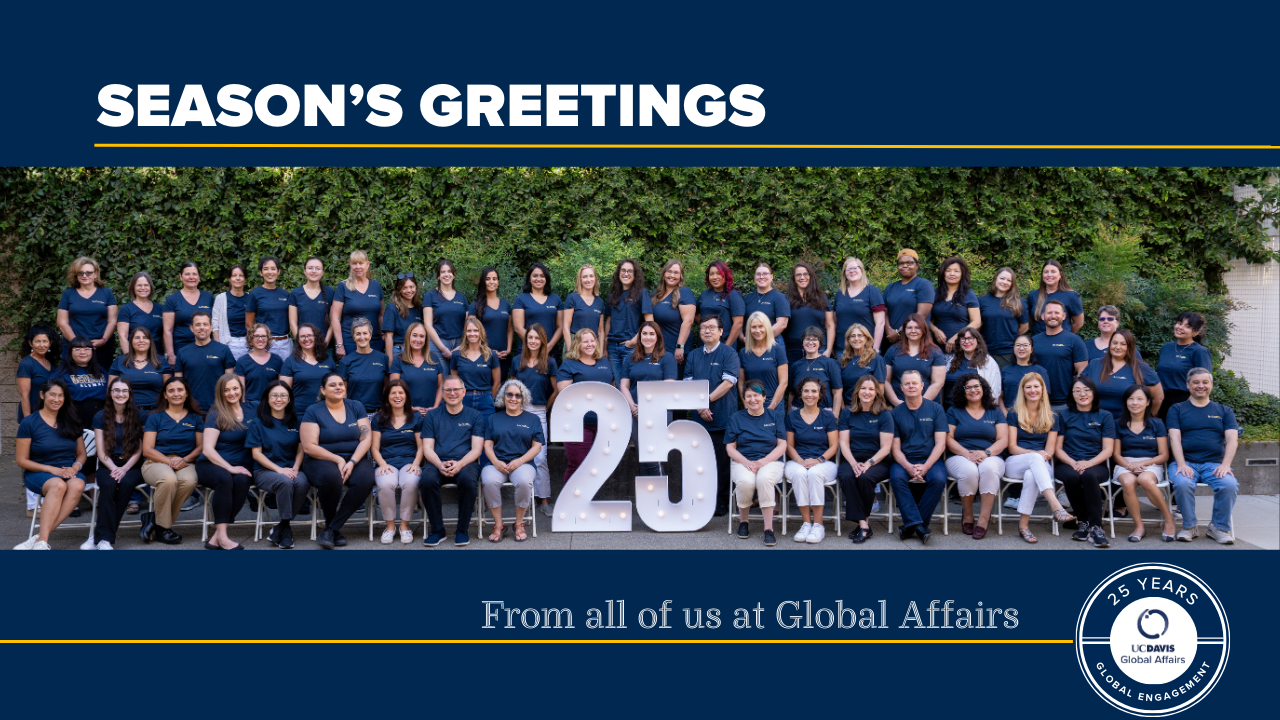 Global Affairs staff gathers around the number 25 to celebrate the 25th anniversary of UC Davis Global Affairs.