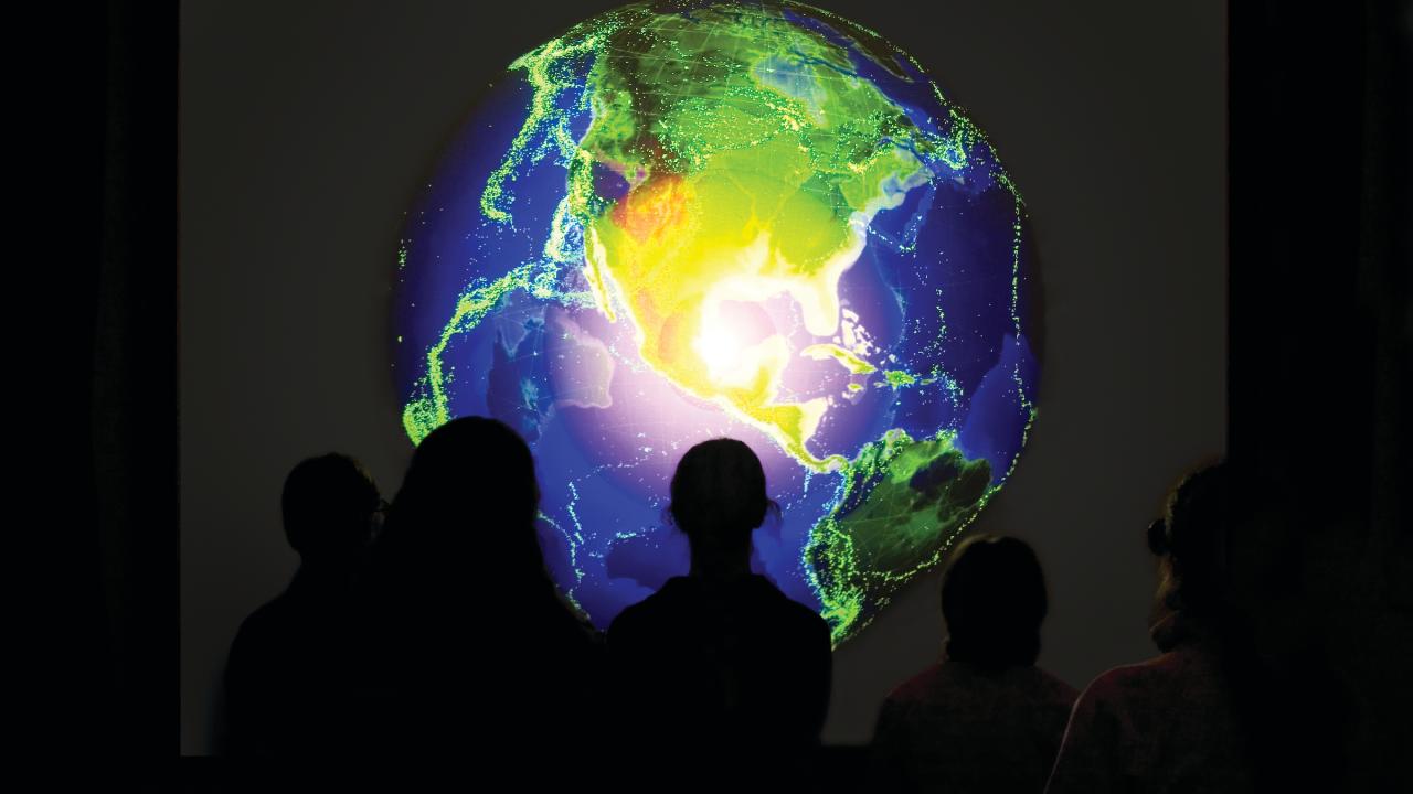 Students look at an image of a globe