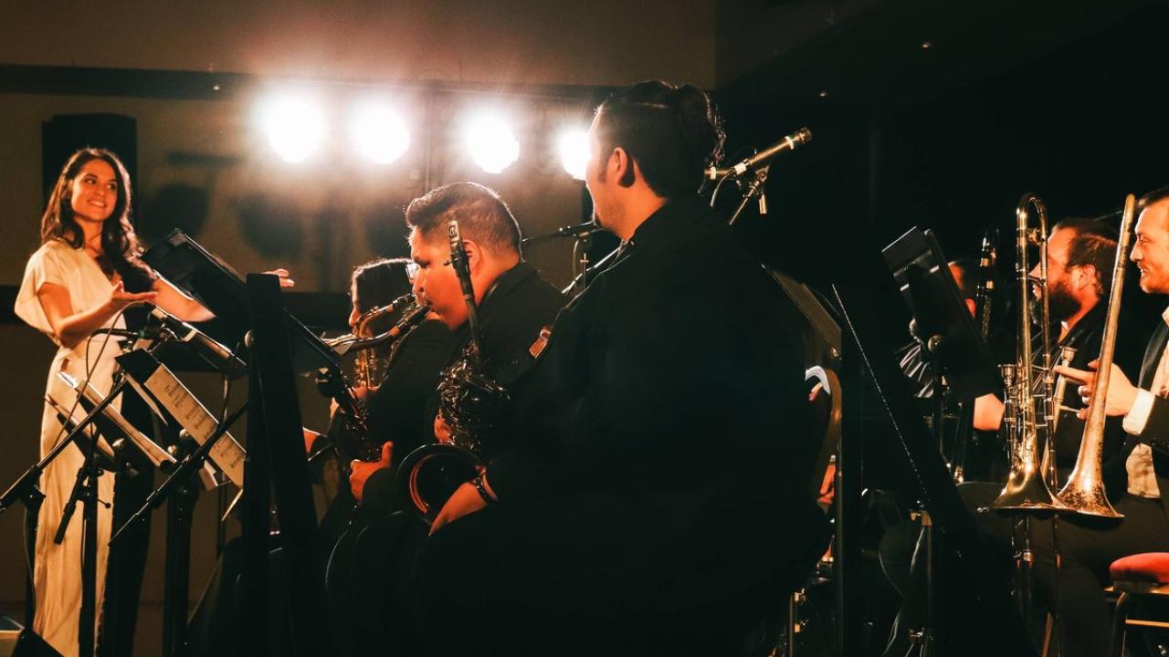 People on a stage playing instruments.