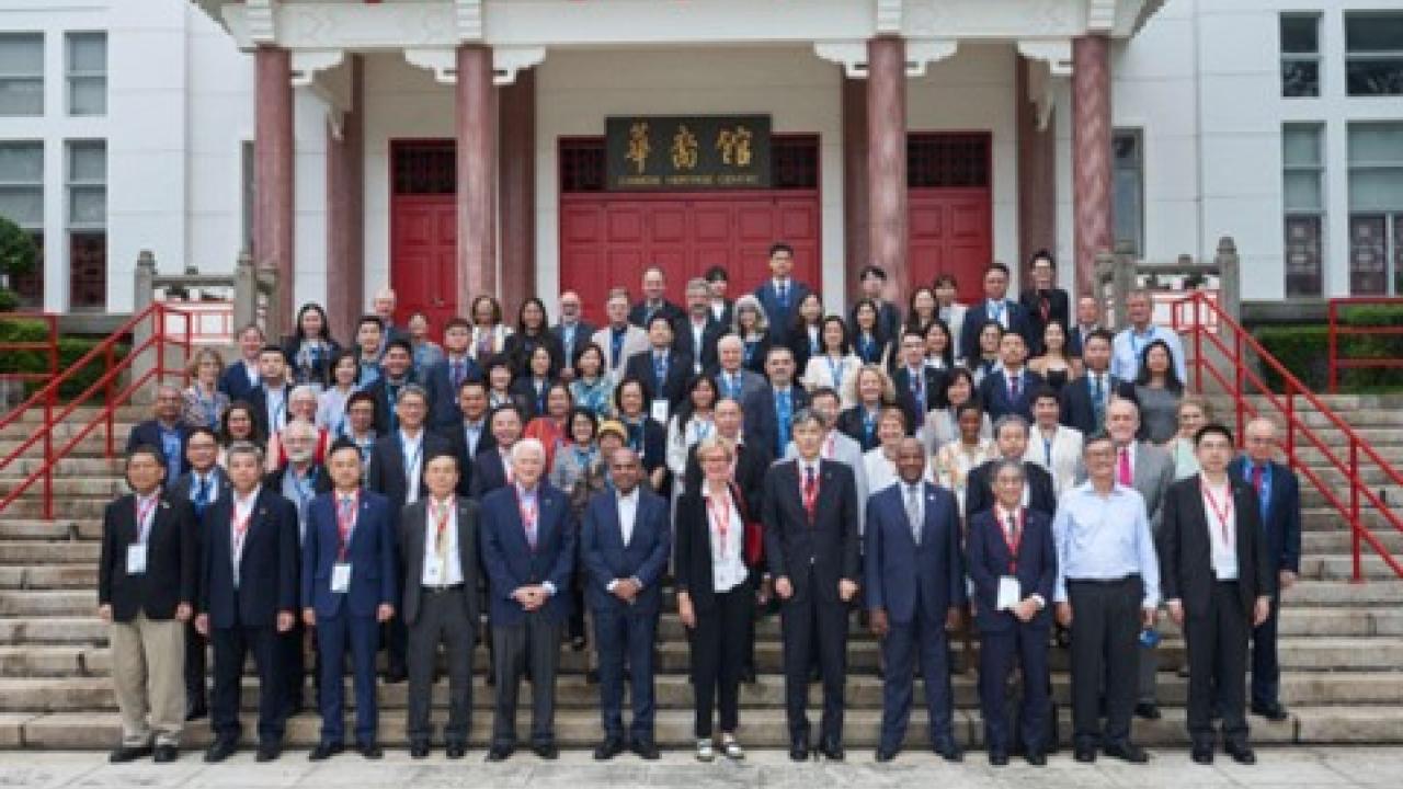 Attendees of the APRU Annual Presidents' Meeting stand for a picture in front of the Chinese Heritage Centre in SIngapore.