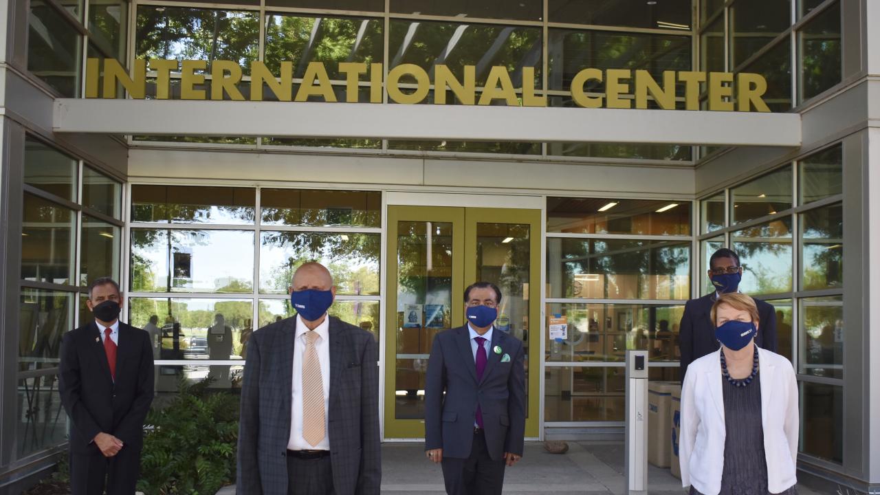 Members from UC Davis and the Pakistani delegation standing outside the International Center on campus