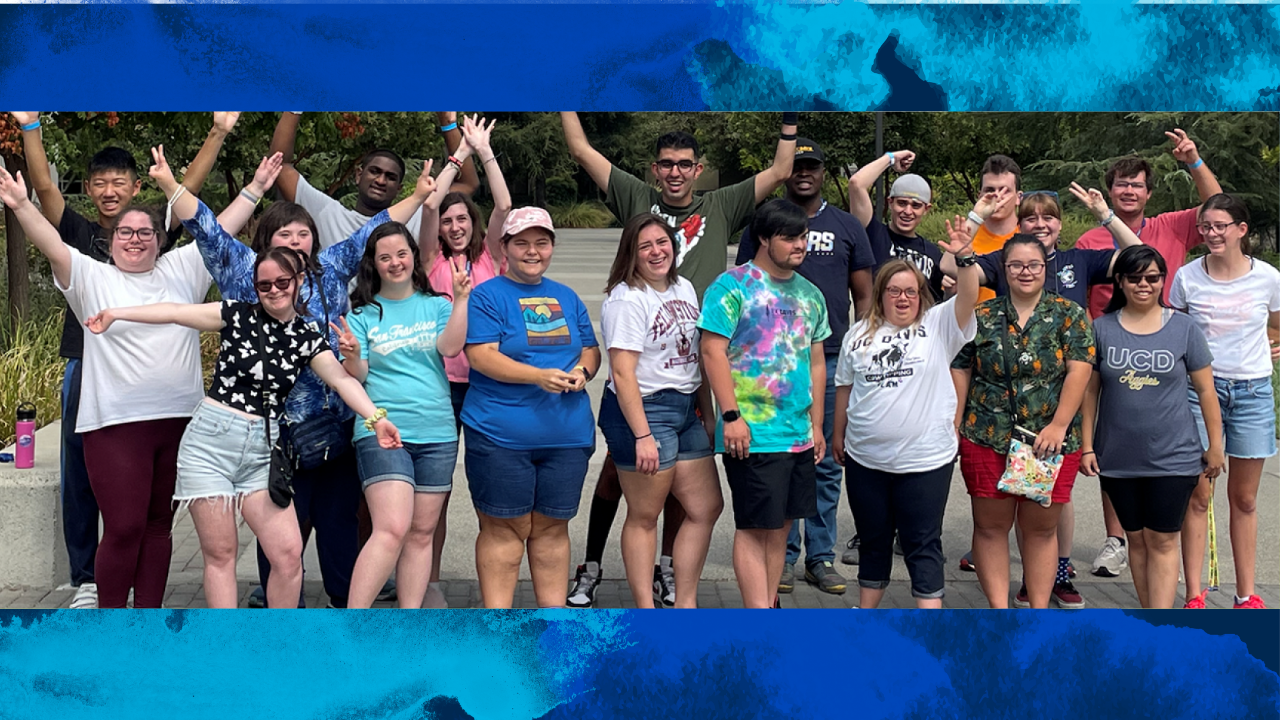 A group of Redwood Seed scholars with arms raised in a group photos and a blue watercolor backround behind them
