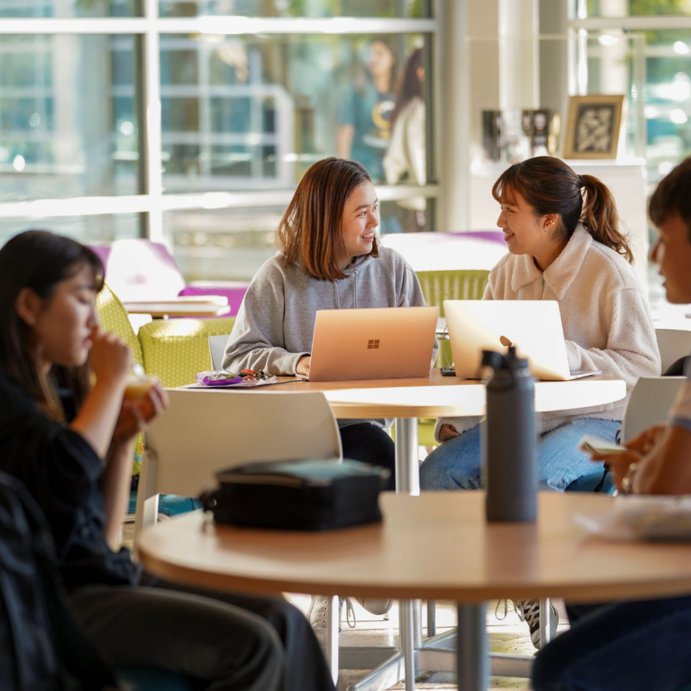 Students converse at a table at the UC Davis International Center