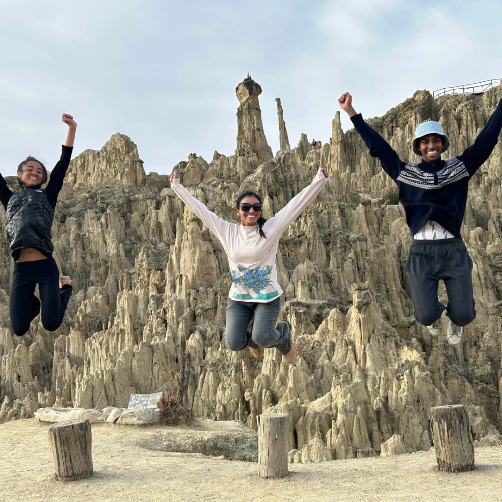 Three students on a UC Davis study abroad program leaping