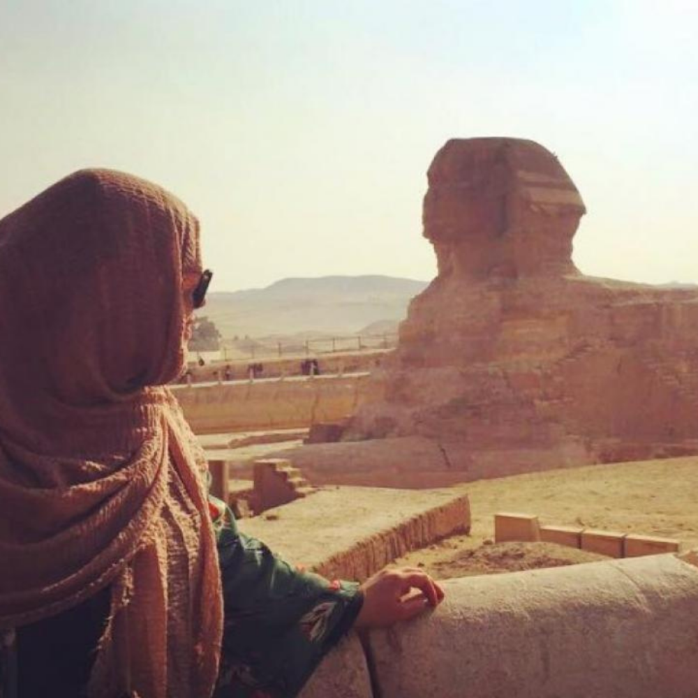 A UC Davis student overlookinging a sphinx in Egypt