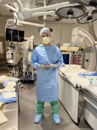 Rawlings stands wearing scrubs in an operation room.