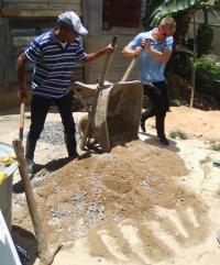 Buggy (right) helps prepare materials during his project in Constanza, Dominican Republic.