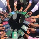 Mandela Fellows holding passports in a circle