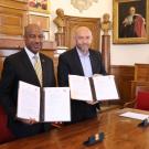 In a photo from @umontpellier on Twitter May 21, Chancellor Gary S. May and Philippe Augé hold up signed documents.