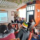 Professor Raquel Aldana and Kari Peterson present a slideshow in front of a group of indigenous rural women in Colombia.