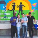 Picture of student team infront of outside mural 