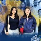 Tina and Suzuran are surrounded by fellow GAMP members with a blue and yellow water color overlay.