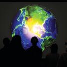 Students look at an image of a globe