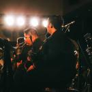 People on a stage playing instruments.