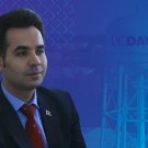 Dr. Alemi headshot over a backdrop of the UC Davis water tower