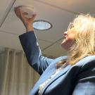 Fritz installing her technology into a ceiling.