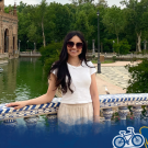 Kate at the Plaza de España in Sevilla, Spain, with global aggies bottom border.