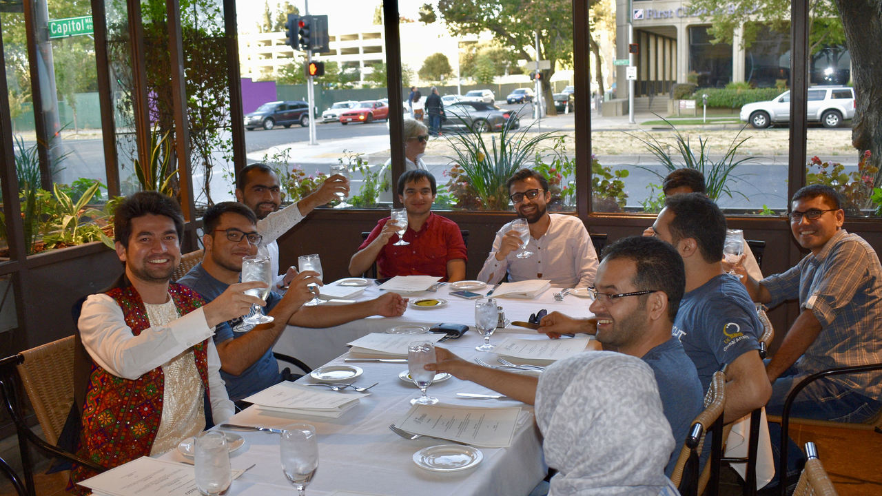 students toast as they enjoy lunch together